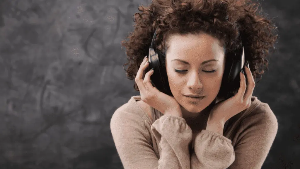 woman listening to music headphones mindful happy