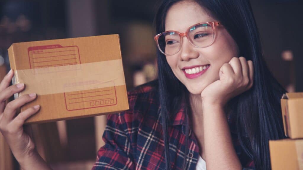 woman holding a shopping box working from home