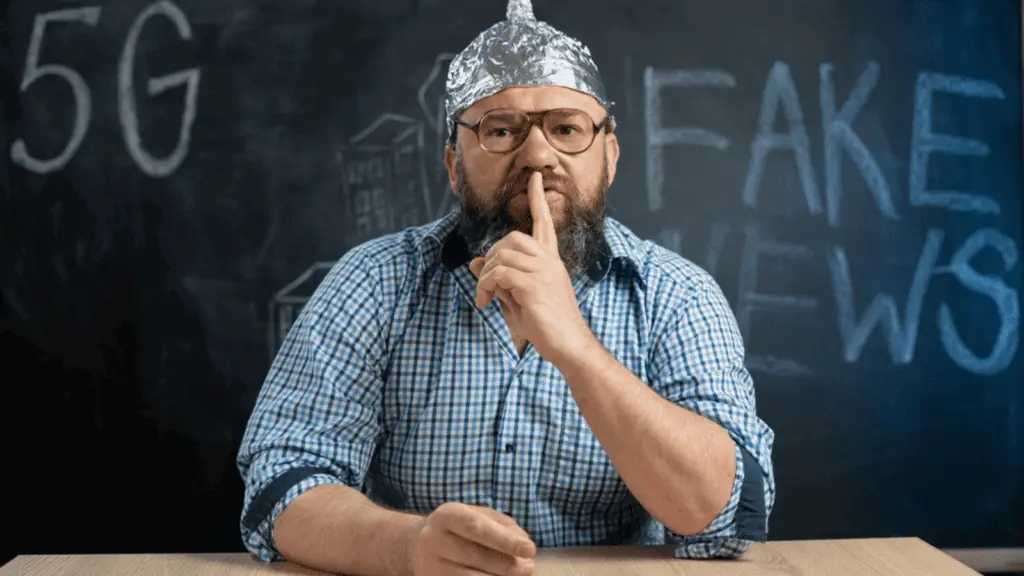 man in a tin foil hat fake news conspiracy theory