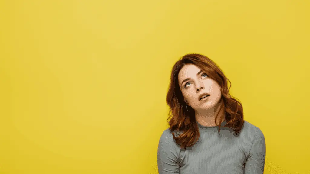 woman rolling her eyes annoyed yellow