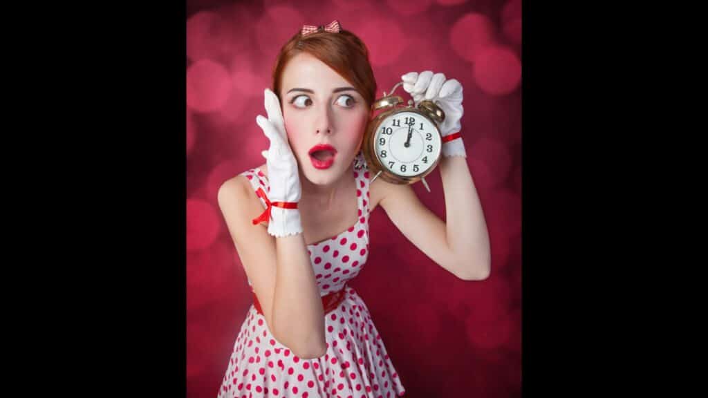 woman holding a clock shocked red lipstick
