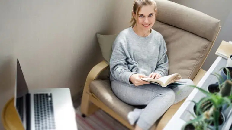 woman enjoying quiet time with a book and computer