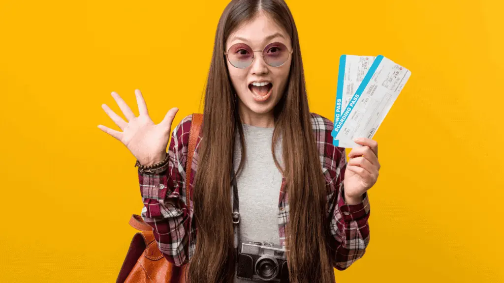 woman excited happy travel flying packed bag airline tickets glasses