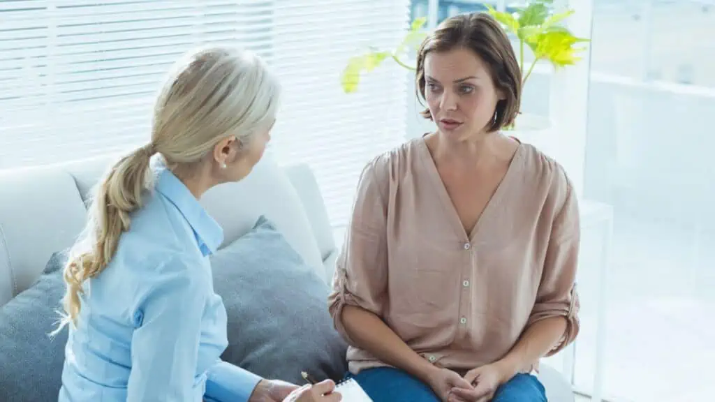 Upset woman talking to therapist