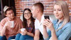 Woman busy with her phone while with her friends