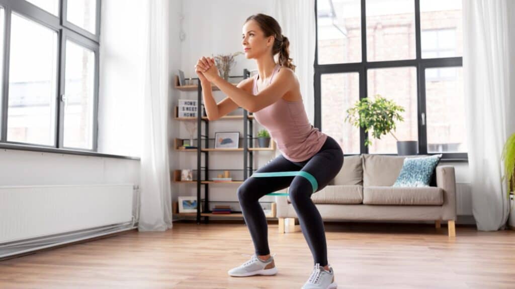 Woman exercising with resistance band at home