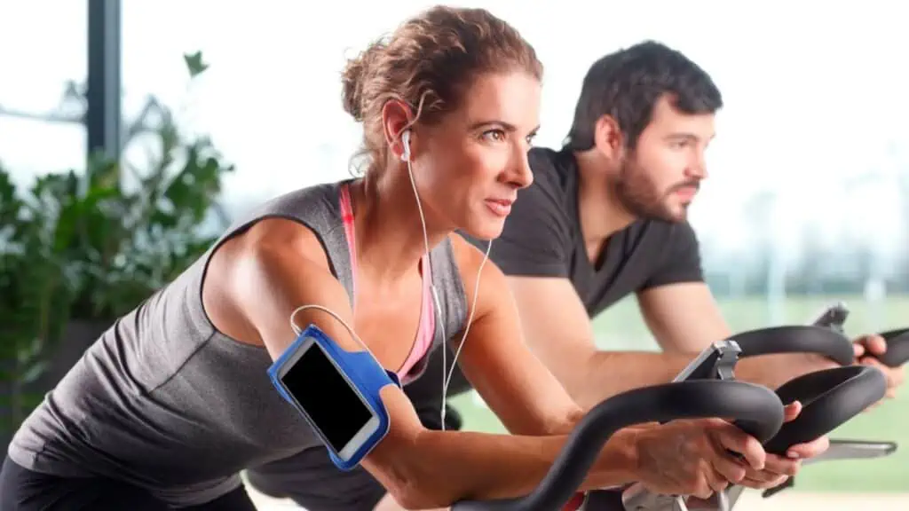 Woman listening to music while in a gym work out