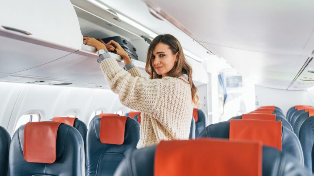 Woman passenger in casual clothes is in the airplane