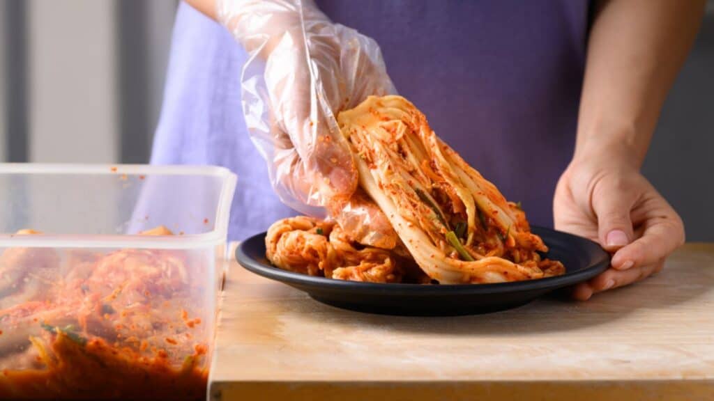 Woman preparing kimchi at home