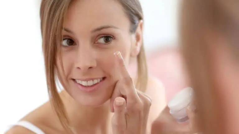 Woman putting anti-aging cream on her face
