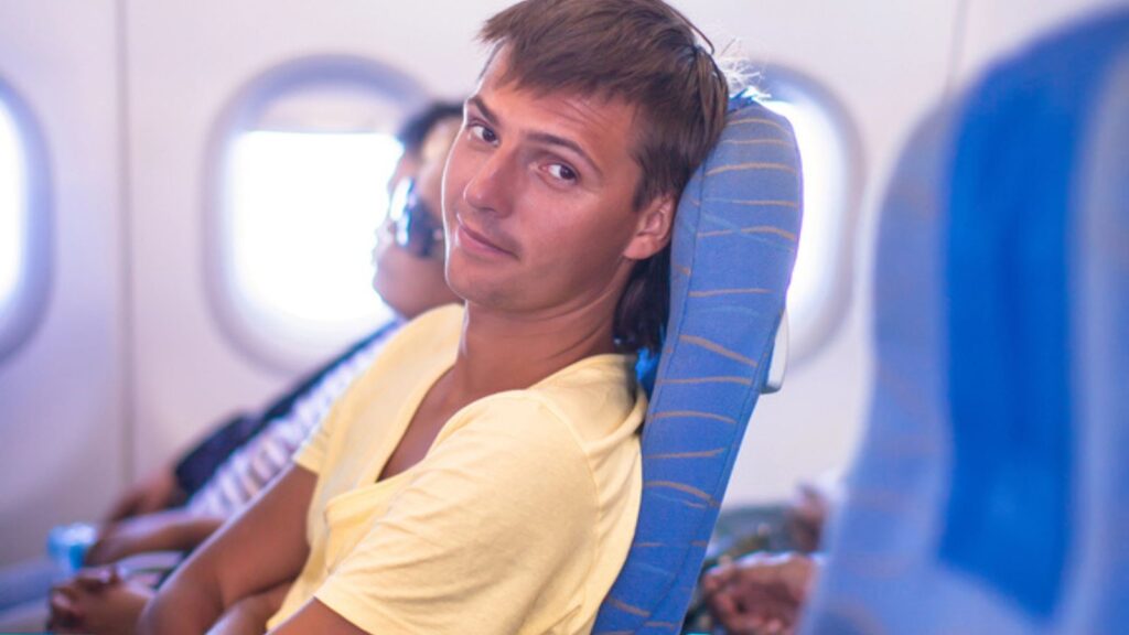 Young man in an airplane during flight