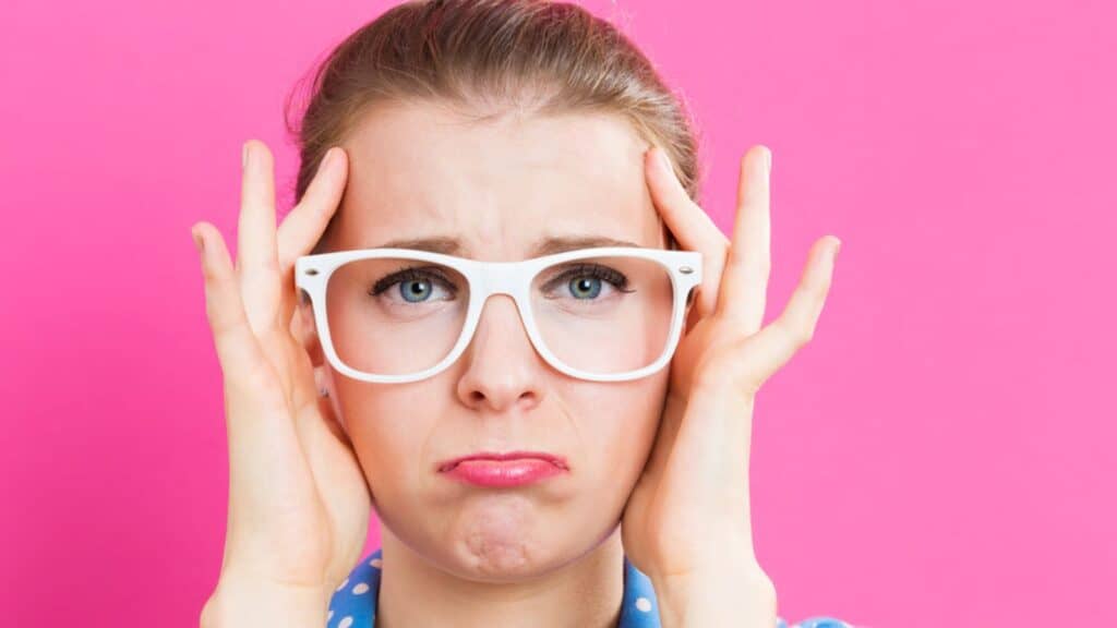Young woman feeling sad and stress isolated in pink