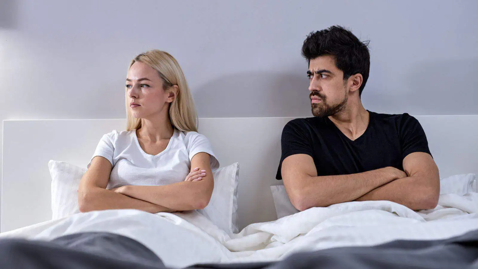angry couple in bed