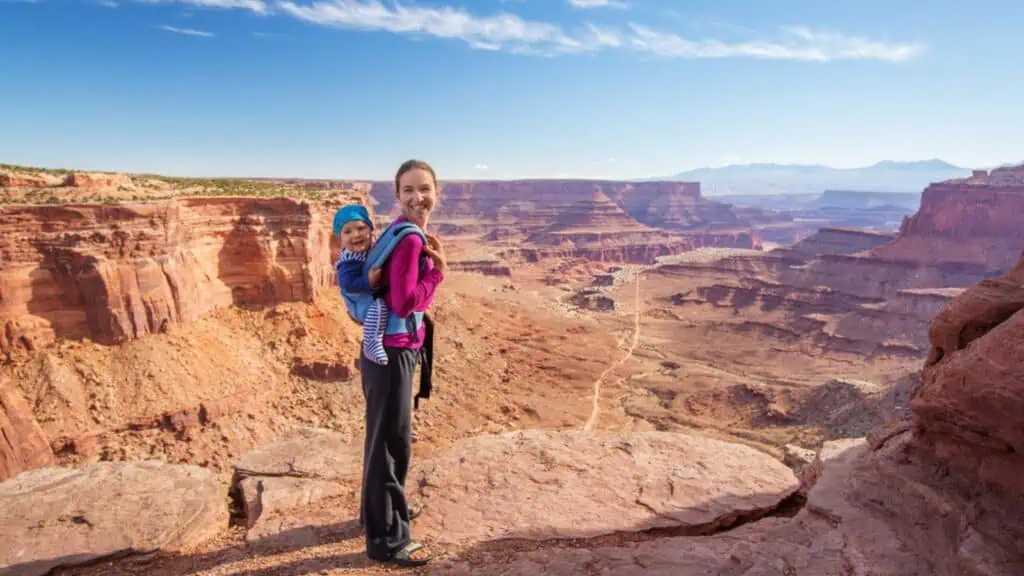 woman and baby traveling nature outside grand canyon happy