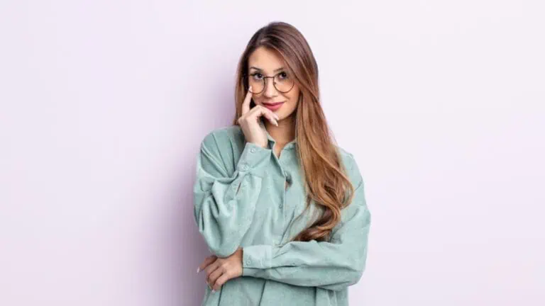 smart woman in glasses with long hair green shirt