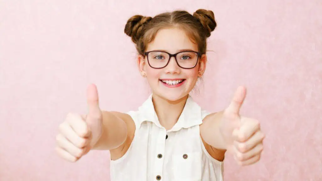 positive happy girl two thumbs up glasses hair buns