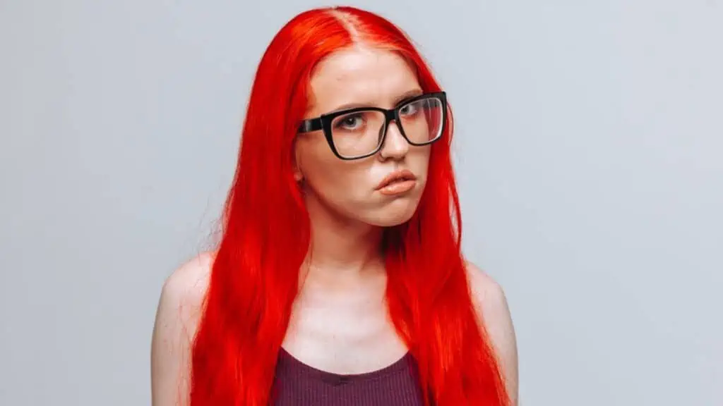 embarrassed teenager red hair glasses confused