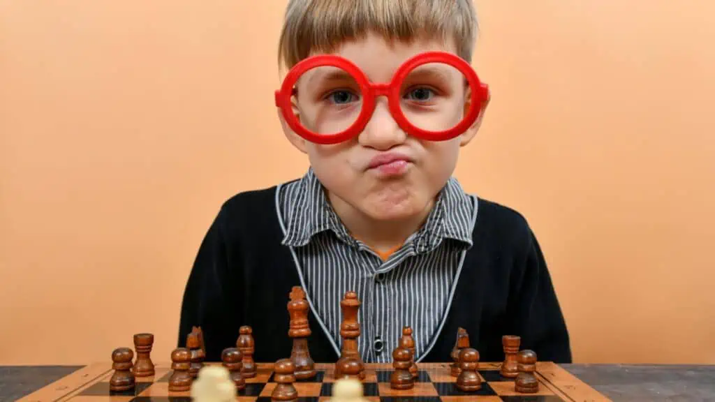 girl playing a board game red glasses chess