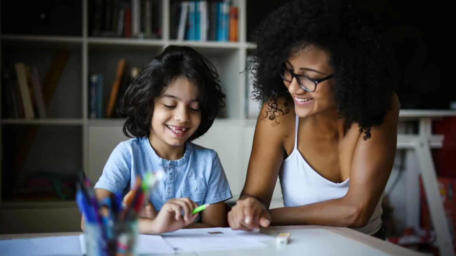 mom and son doing homework happy