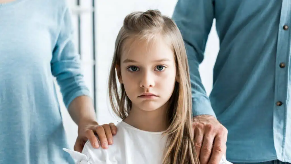 sad girl with her parents