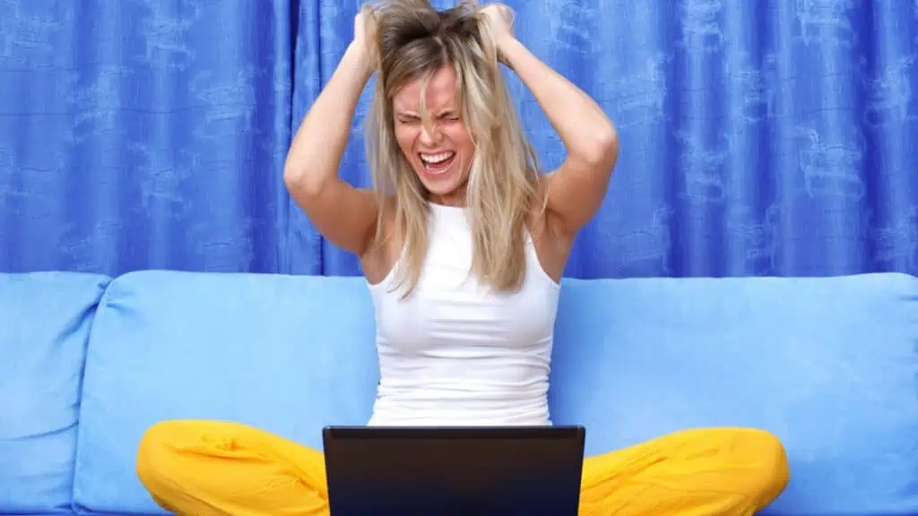 frustrated woman at the computer pulling out her hair