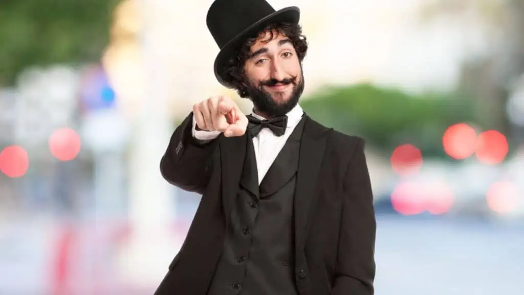 conceded man in a suit top hat smug