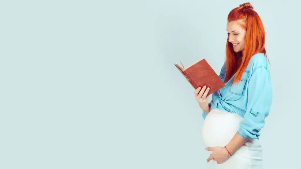 woman reading a book pregnant