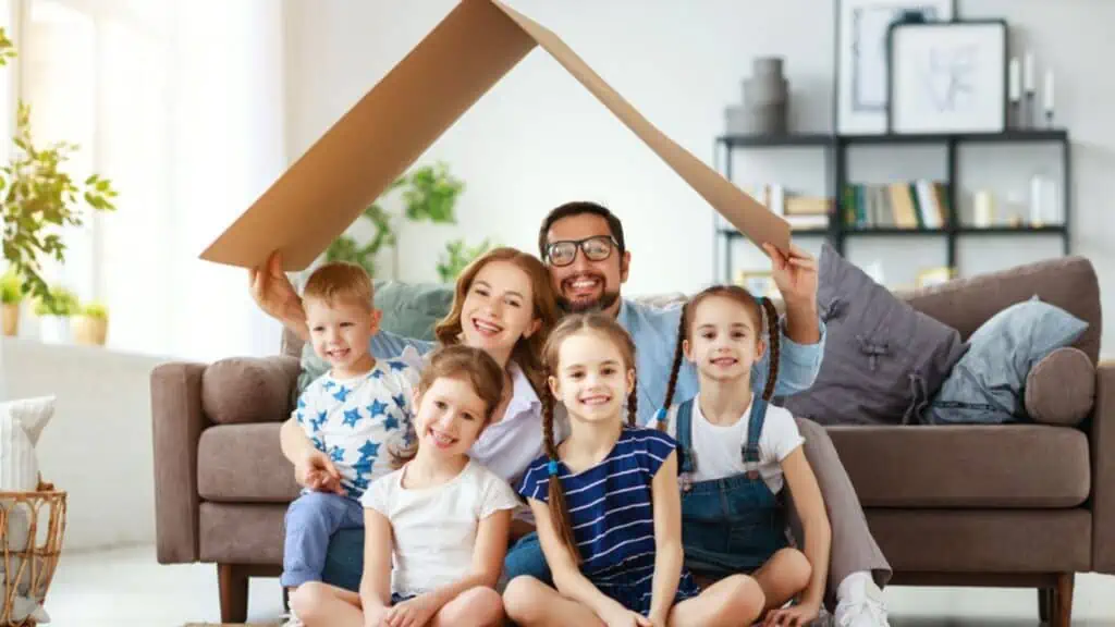 family in the living room with a cardboard box