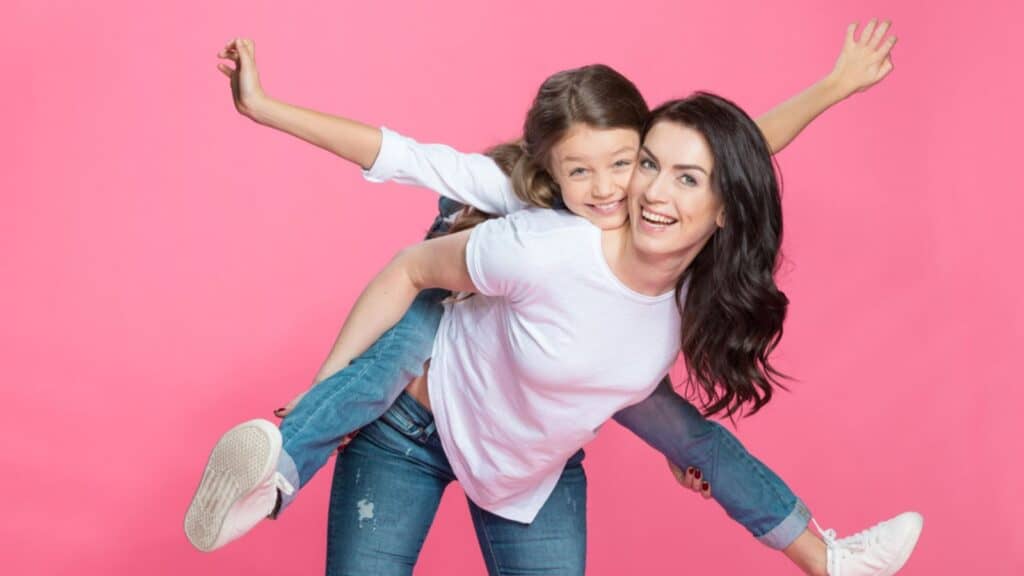 mom and daughter happy piggy back