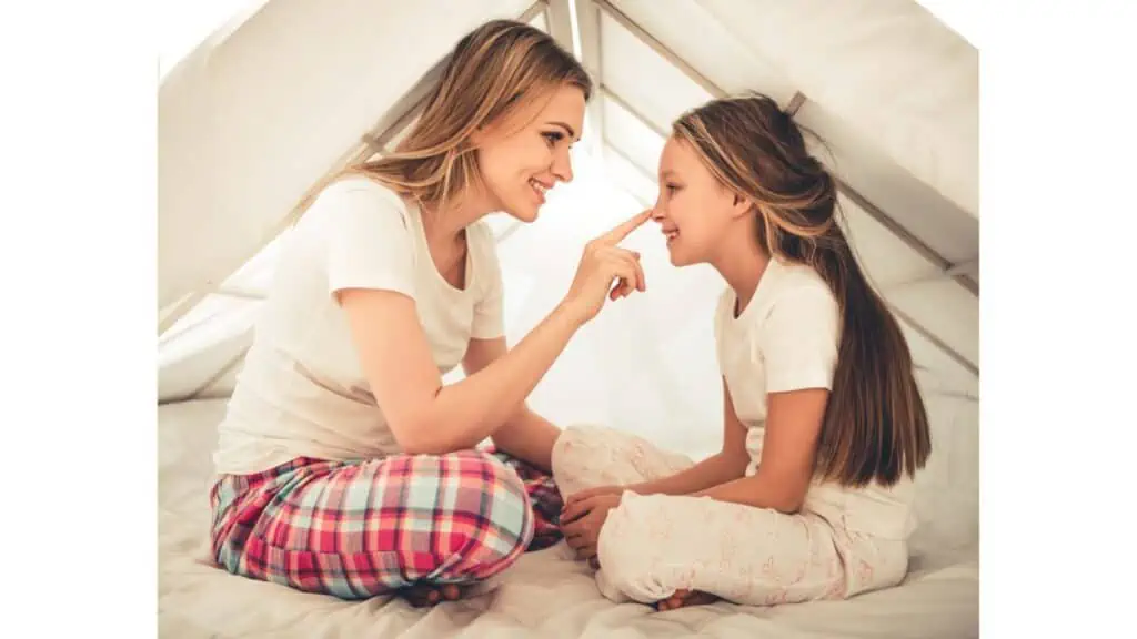 mom and daughter in a tent happy love