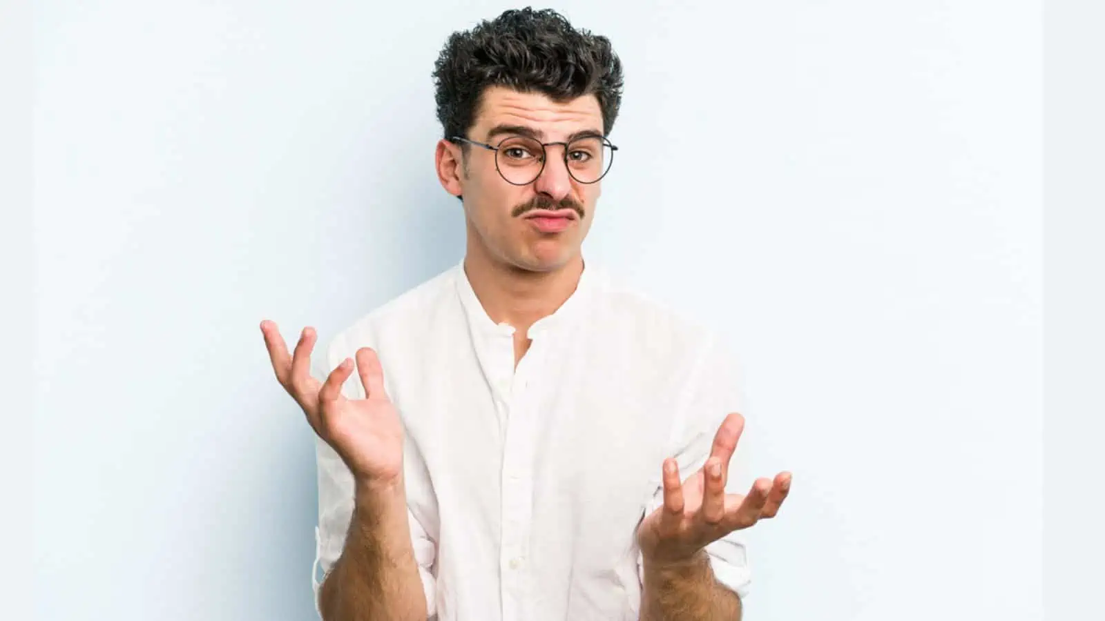 confused caucasian man isolated on blue background