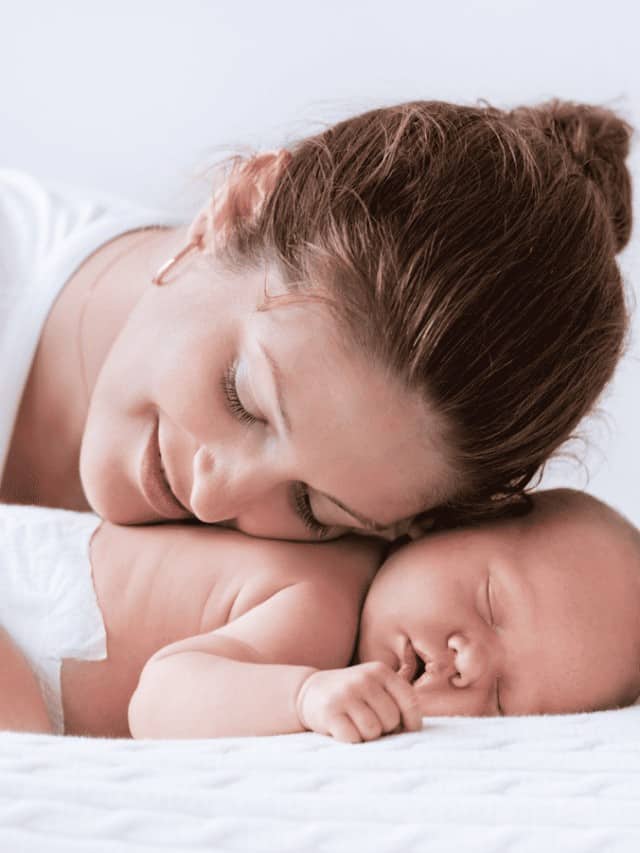 happy mom and sleeping newborn baby
