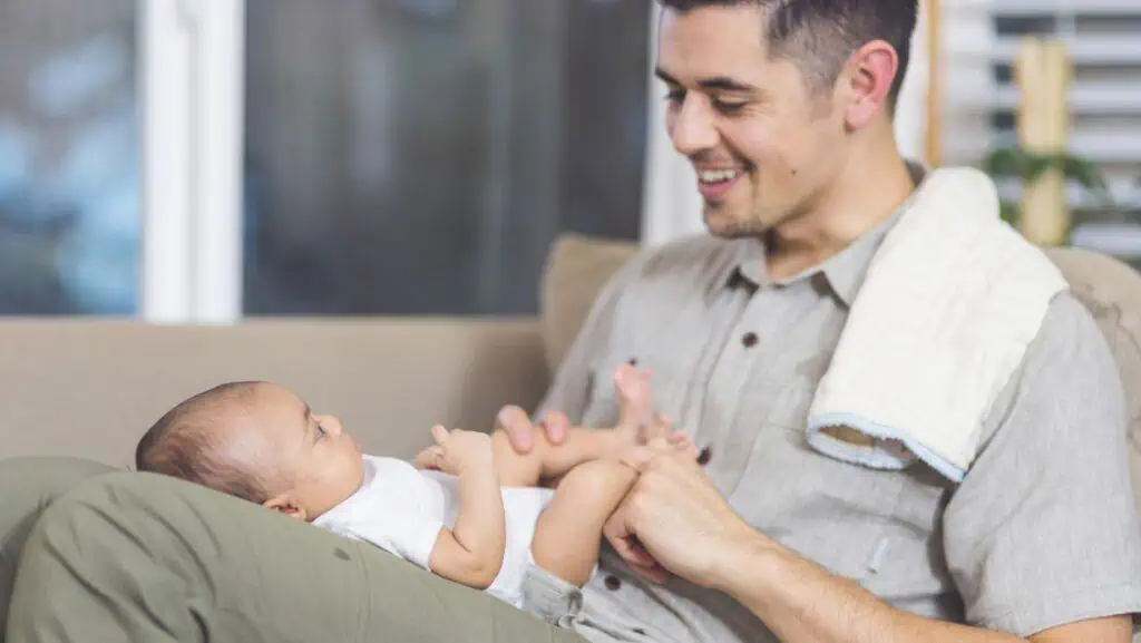 Dad playing with newborn