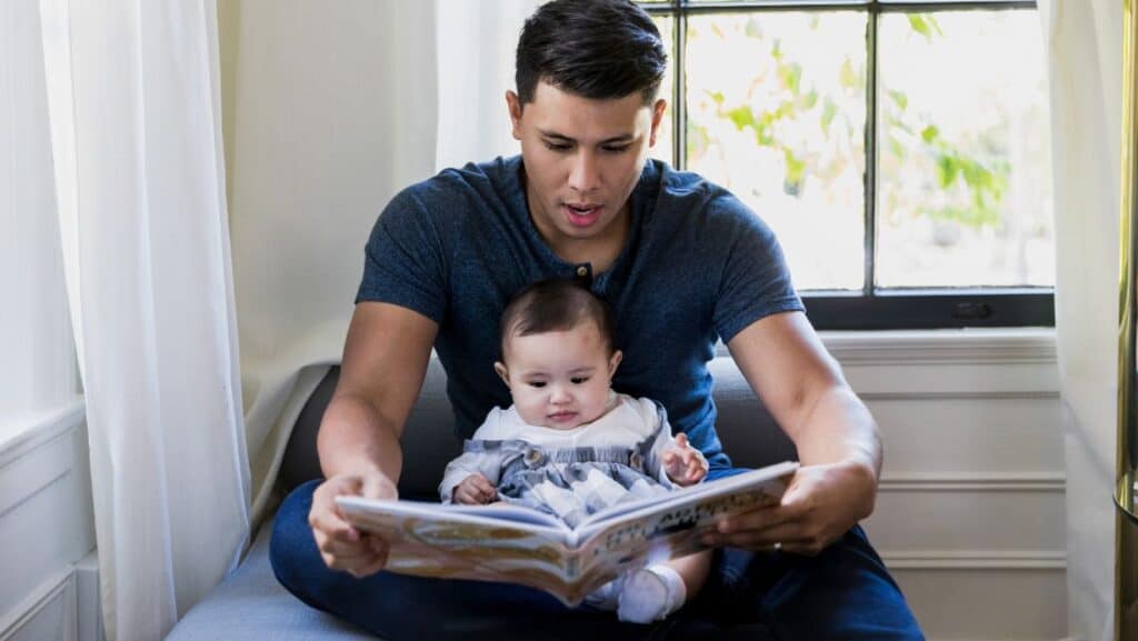 dad-reading-book-with-newborn