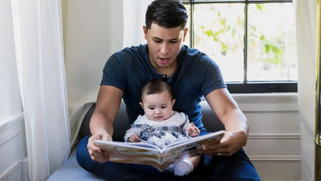 dad-reading-book-with-newborn