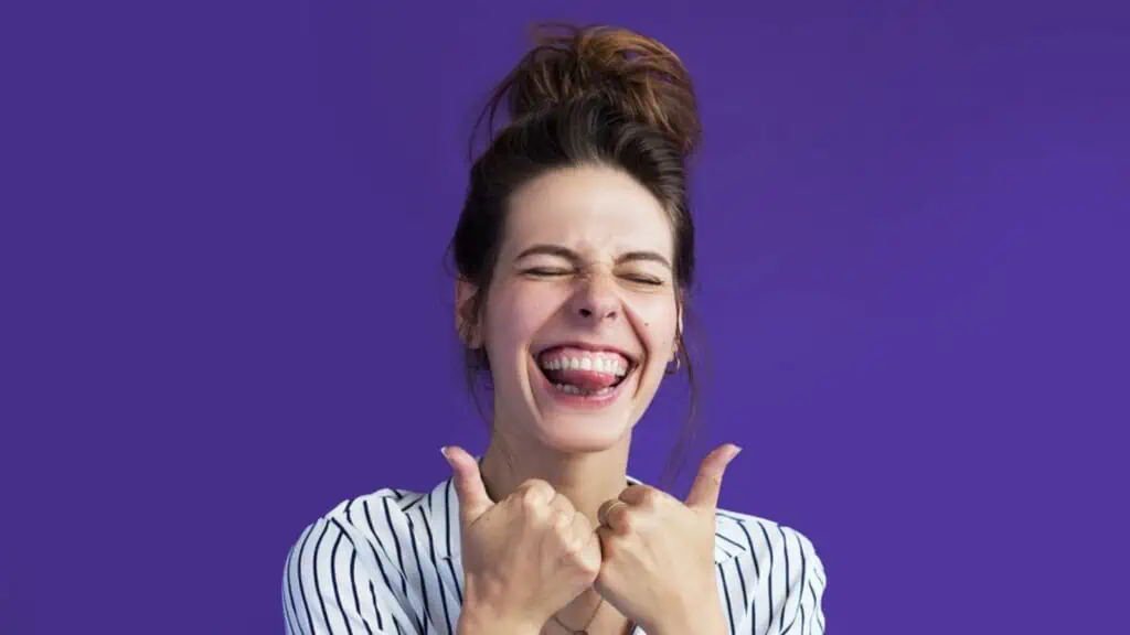 laughing excited woman showing thumbs up