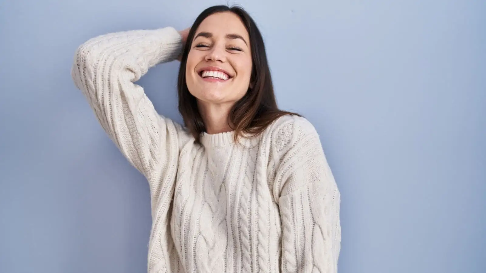 laughing woman standing over grey background