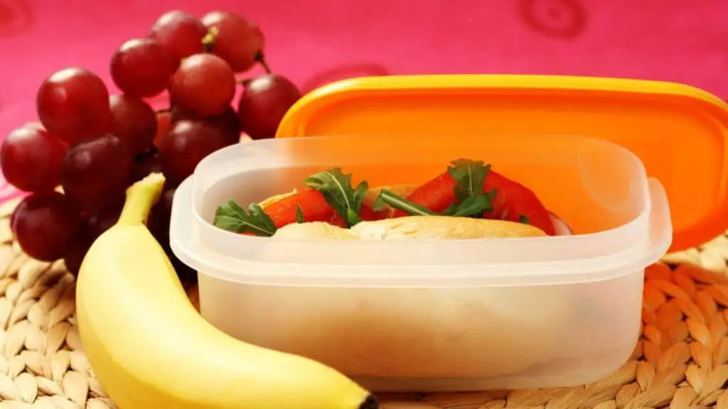 lunch box with banana grapes sandwich