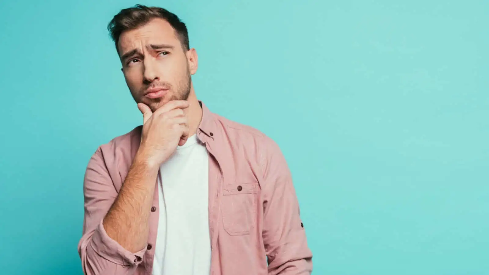 thinking handsome man gesture and looking up isolated on blue