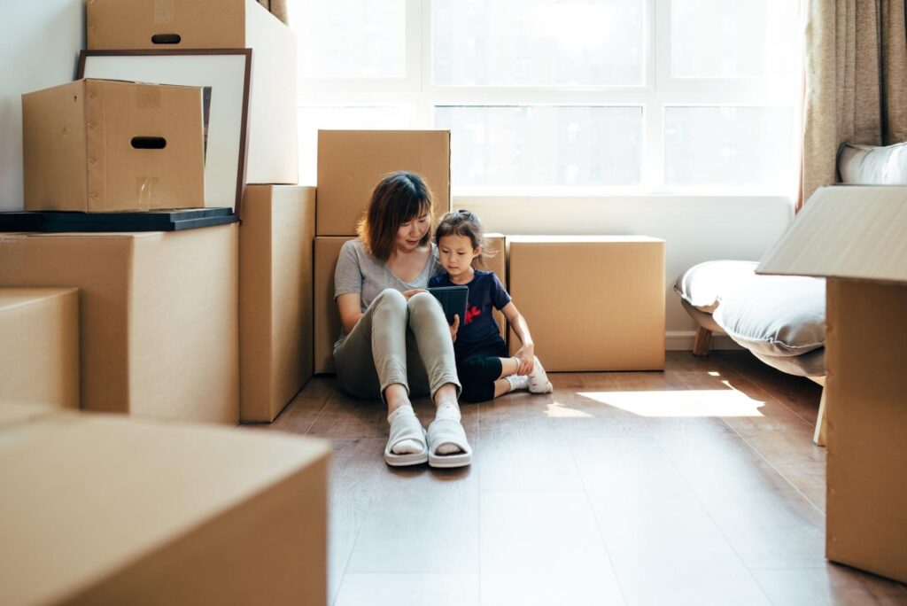 mom and daughter moving with boxes