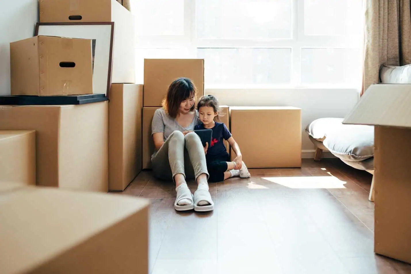 mom and daughter moving with boxes